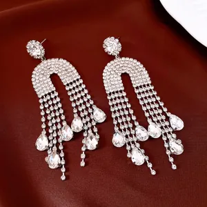 Detailed shot of sparkling rhinestone tassel earrings with teardrop crystal drops