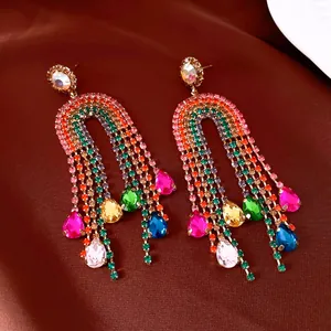 Detailed view of rainbow rhinestone tassel earrings with multi-color teardrop gems