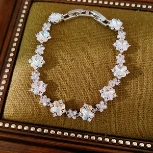Detailansicht eines glitzernden Blumenarmbands mit schillernden Steinen auf Samt.
