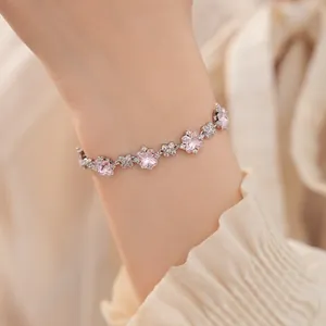 Nahaufnahme eines silbernen Blumenarmbandes mit funkelnden rosa Zirkonia-Steinen