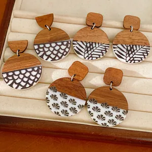 Detail view of retro wood and resin round earrings with unique prints in a jewelry box