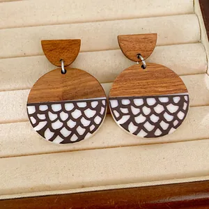 Detail view of ethnic retro round wood and resin earrings with scale pattern print