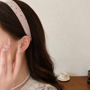 Elegant French vintage acrylic headband with colorful rhinestones worn by a model