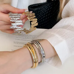 Minimalist gold and silver textured metal open cuff bracelets for women.