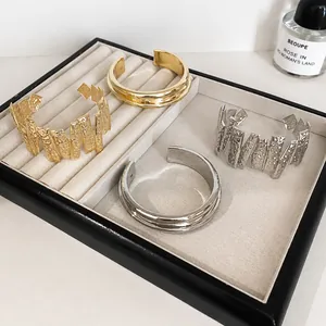 Chic metal open bangles with smooth and textured finishes in gold and silver set