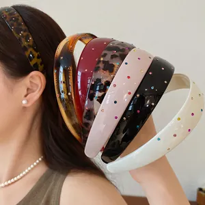 Detailed view of retro acrylic headbands with colorful rhinestones in various chic patterns
