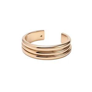 Elegant minimalist gold-toned metallic cuff bracelet with a stylish tiered ribbed design