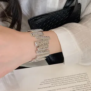 Close-up of a silver textured metallic bracelet with an irregular hammered design