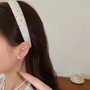 Elegant French vintage white acrylic headband with colorful rhinestones worn by a model