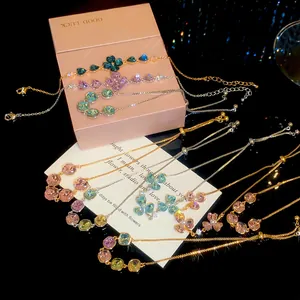 Detailed view of 18k gold plated bracelets with colorful zircon clover and square charms