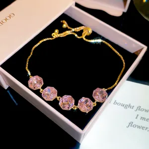 Close-up of elegant 18k gold plated bracelet featuring five sparkling pink zircons in gift box.