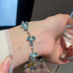 Elegant close-up of a light blue crystal flower bracelet with small pearl centers on a wrist