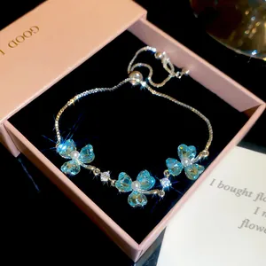Close-up of elegant 18k gold plated bracelet with blue butterfly crystals and pearls