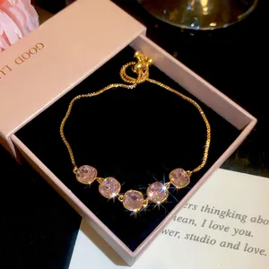 Detail of 18k gold plated bracelet with sparkling lavender zircon stones in gift box