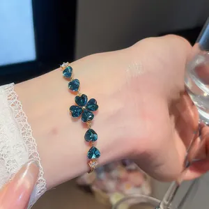 Detailed macro shot of an 18k gold plated bracelet with sparkling blue heart zircons