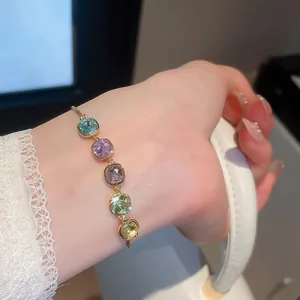 Detailed close-up of sparkling colorful square zircon bracelet with 18k gold plating