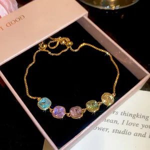 Detail of 18k gold plated bracelet with five colorful square cubic zirconia stones