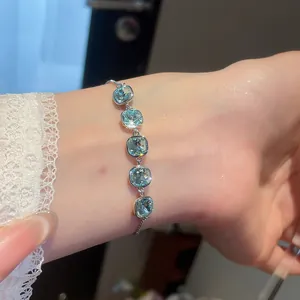 Elegant 18k gold-plated bracelet with five sparkling light blue square zircons on wrist