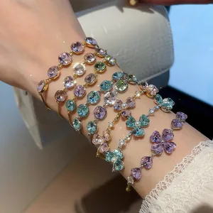 Detailed close-up view of colorful zircon and pearl bracelets with 18k gold plating on wrist