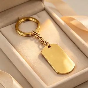 Close-up of a gold-polished blank dog tag keychain in a premium jewelry gift box