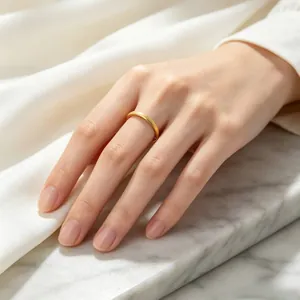 Detailed view of elegant gold frosted star titanium steel ring on a white marble base