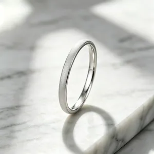 Close-up of elegant silver titanium steel ring with frosted starry texture on marble