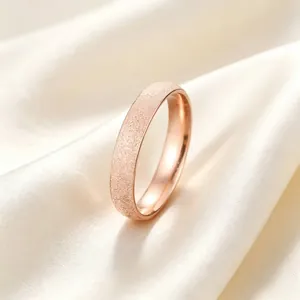 Close-up macro view of the elegant rose gold stardust frosted texture on titanium steel ring