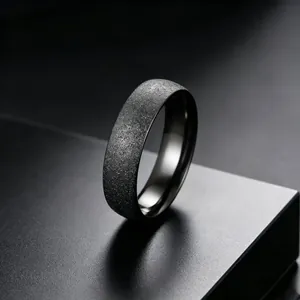 Detailed close-up view of a matte black titanium steel ring with a starry frosted texture