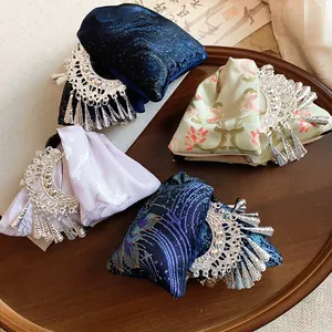Detailed view of ethnic style embroidered hair clips featuring silver metallic fringe