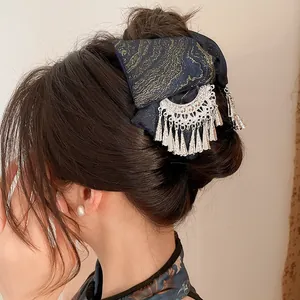 Detailed view of New Chinese style fabric hair clip with silver tassels and embroidery