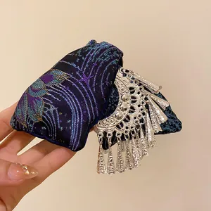 Detail of New Chinese ethnic style embroidered triangle hair claw with silver tassels