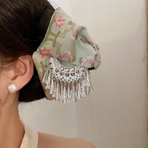 Detailed view of ethnic embroidered hair claw clip with silver tassels for Hanfu hairstyle