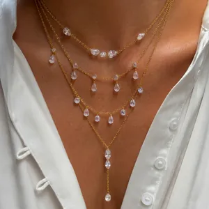 Close-up of a layered gold stainless steel necklace with elegant teardrop zircons.