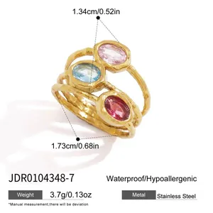 Stainless steel golden ring featuring three layered bands with oval pink and blue zircons