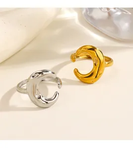 Macro detail showing texture of crescent moon open ring in gold and silver stainless steel
