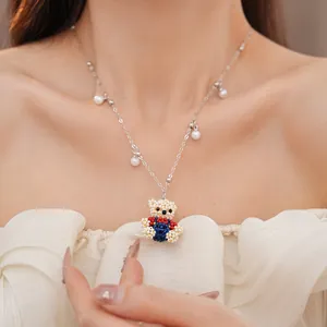 Detailed view of the handmade beaded bear pendant necklace featuring white pearl charms