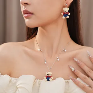 Detailed view of a cute handmade beaded bear pendant necklace on a model's neck.