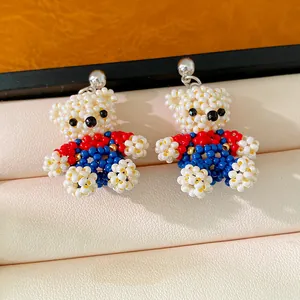 Detailed view of hand-beaded teddy bear stud earrings made with colorful glass beads