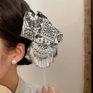 Detailopname van een etnische batik haarklem met sierlijke zilveren kwastjes in Miao-stijl