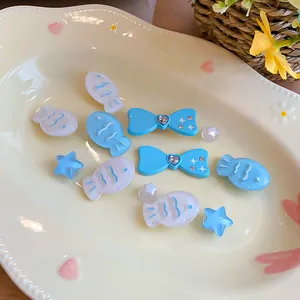 Detailed view of DIY resin accessories in fish, bow, and star shapes on a plate