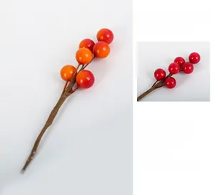 Close-up detail of handmade artificial Christmas berries for DIY floral arrangements.