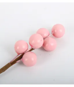 Macro detail of artificial pink berries for DIY Christmas holiday floral arrangements