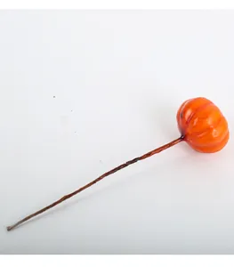Single miniature artificial orange pumpkin pick for DIY autumn and holiday floral arrangements