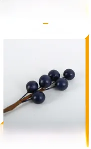 Detailed view of deep blue artificial berry stems for Christmas DIY floral decor