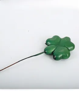Detailed view of an artificial green four-leaf clover stem for DIY flower arrangement