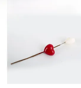 Detail view of red and white heart-shaped artificial flower decorative picks for DIY crafts.
