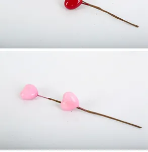 Macro detail view of red and pink heart-shaped artificial flower picks for DIY decor