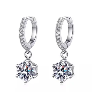 Close-up of 925 sterling silver hoop earrings with six-prong set brilliant-cut stones