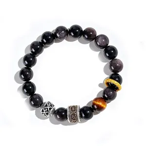 Macro view of 10mm silver obsidian beads and engraved mantra cylinder bead on bracelet.