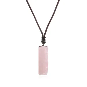 Detailed view of a rectangular pink rose quartz pendant on a brown handcrafted woven cord.